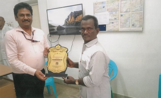 Trust member receiving a memento from an official
